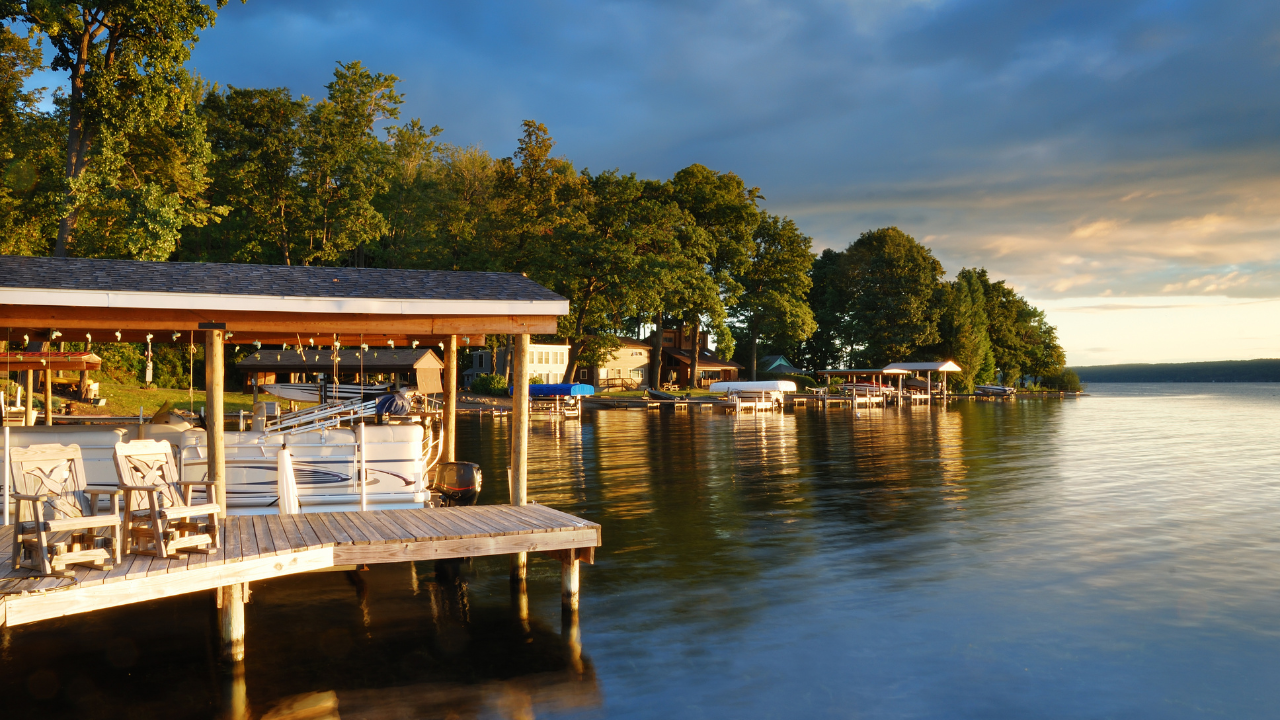 A beautiful lakefront home on Mullett Lake with a dock and a boat in the water.